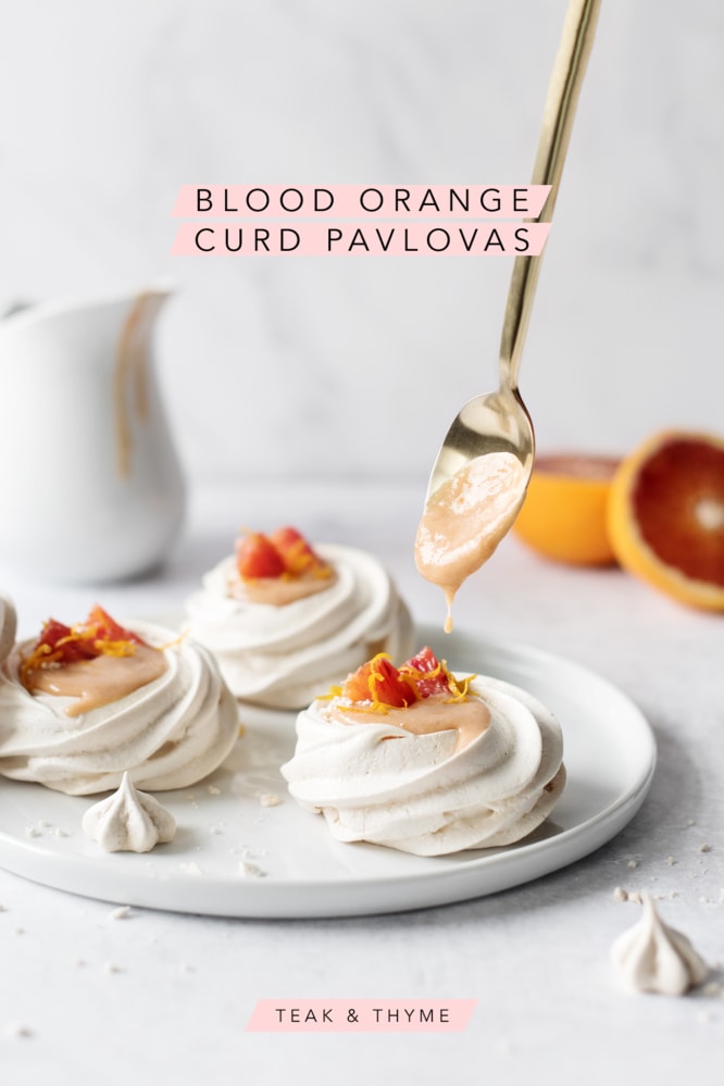 Spoonful of blood orange curd dripping into mini pavlovas
