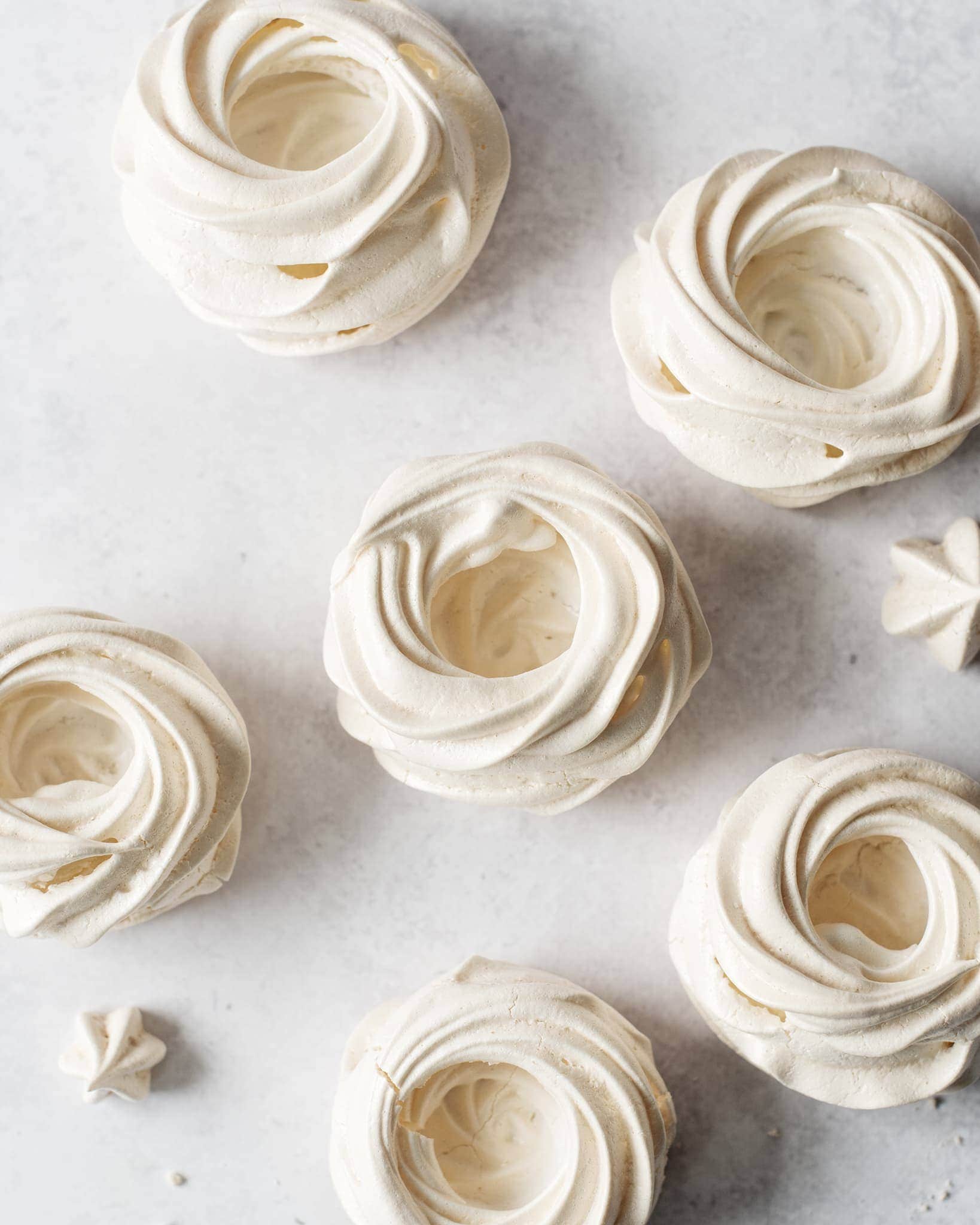 Overhead shot of empty pavlova meringues before being filled with curd