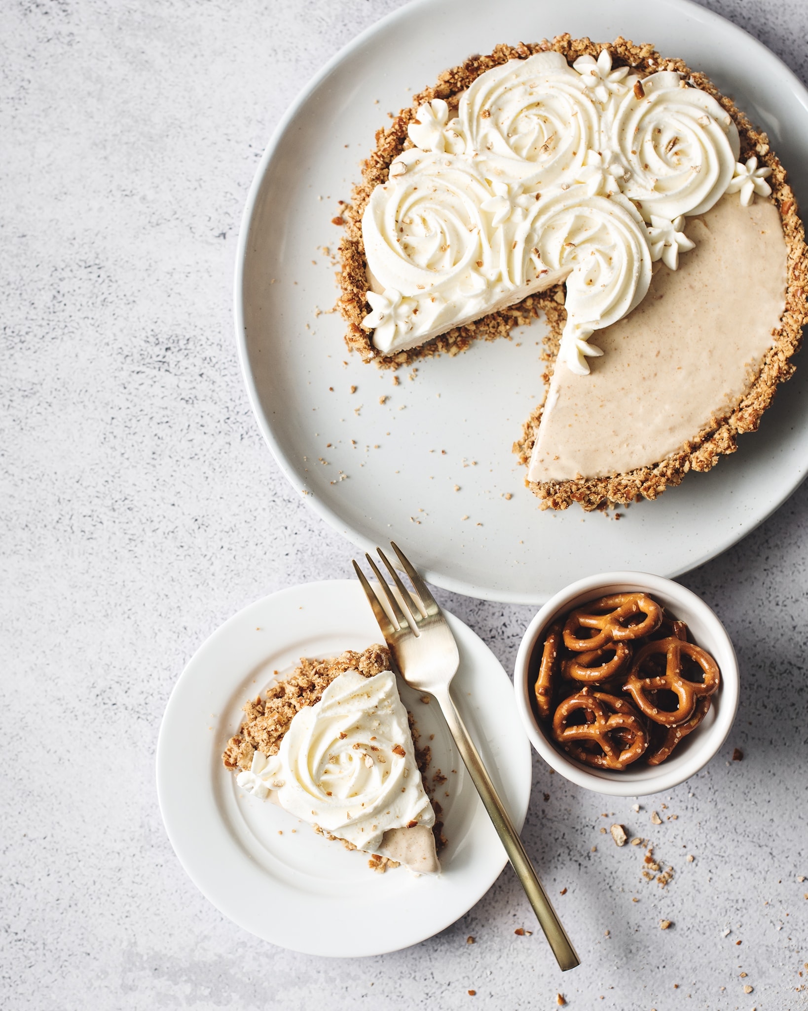 One slice of peanut butter ice cream pie next to the rest of the pie