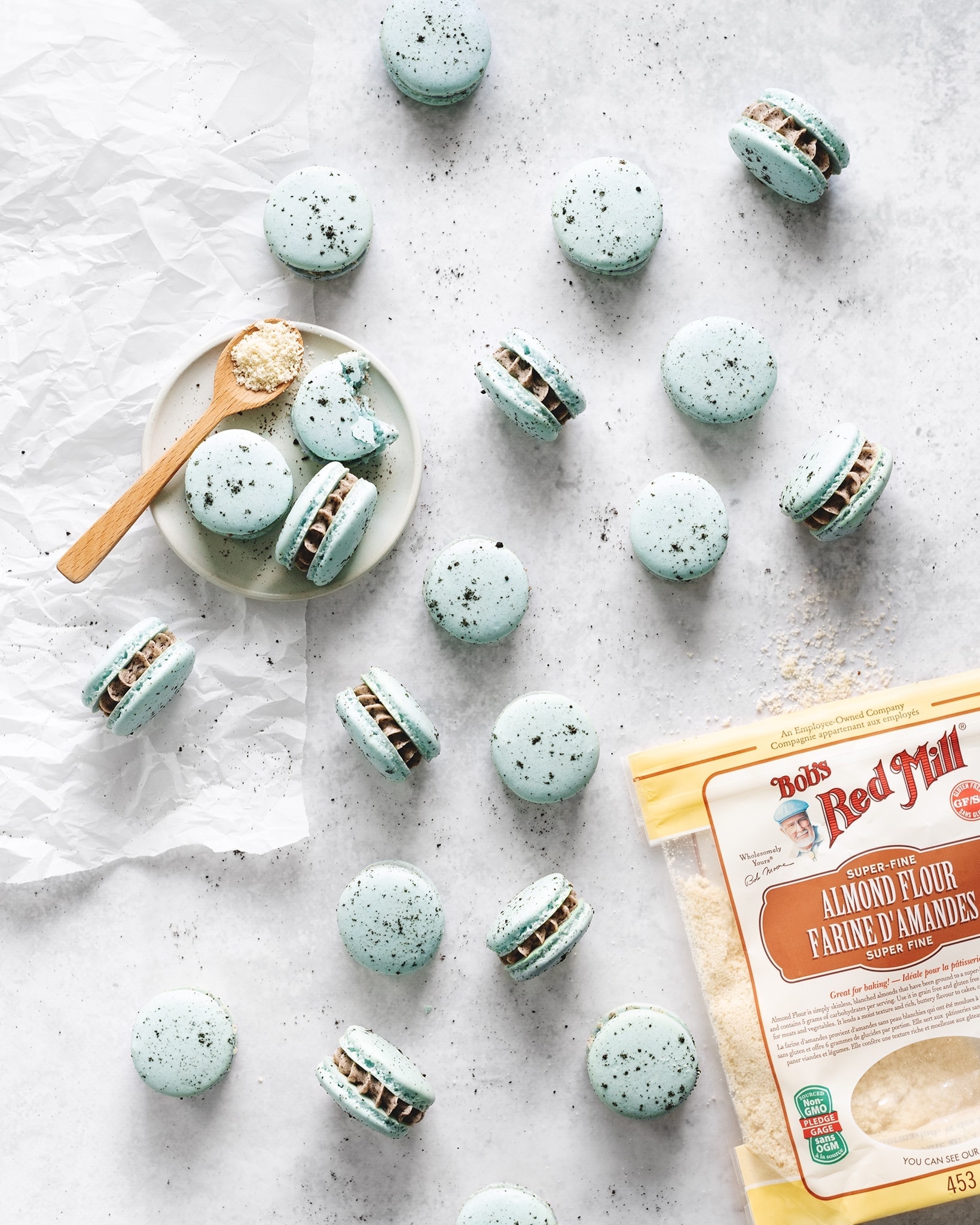 Scattered macarons with bag of almond flour