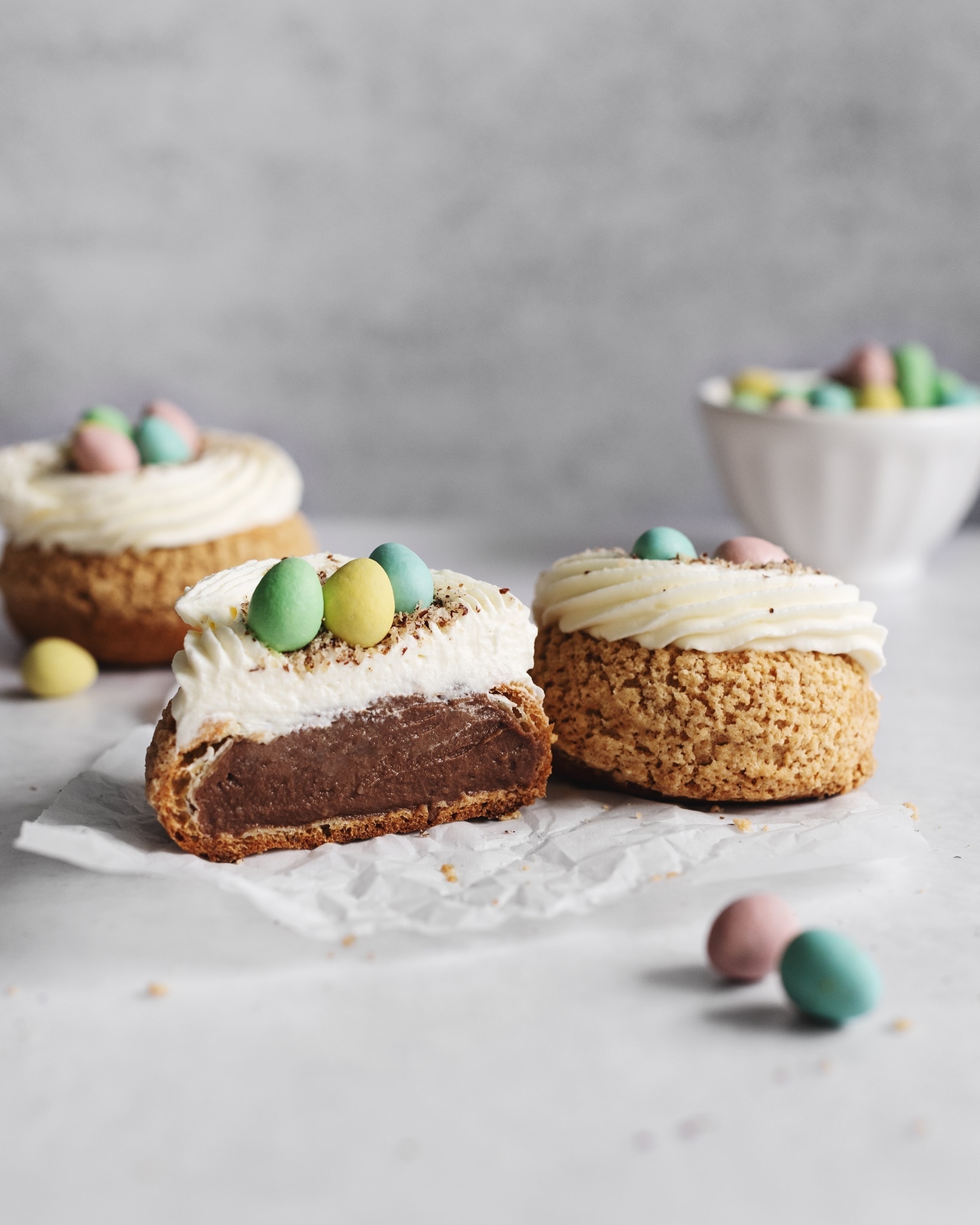 Cream puff cut in half to show chocolate pastry cream inside