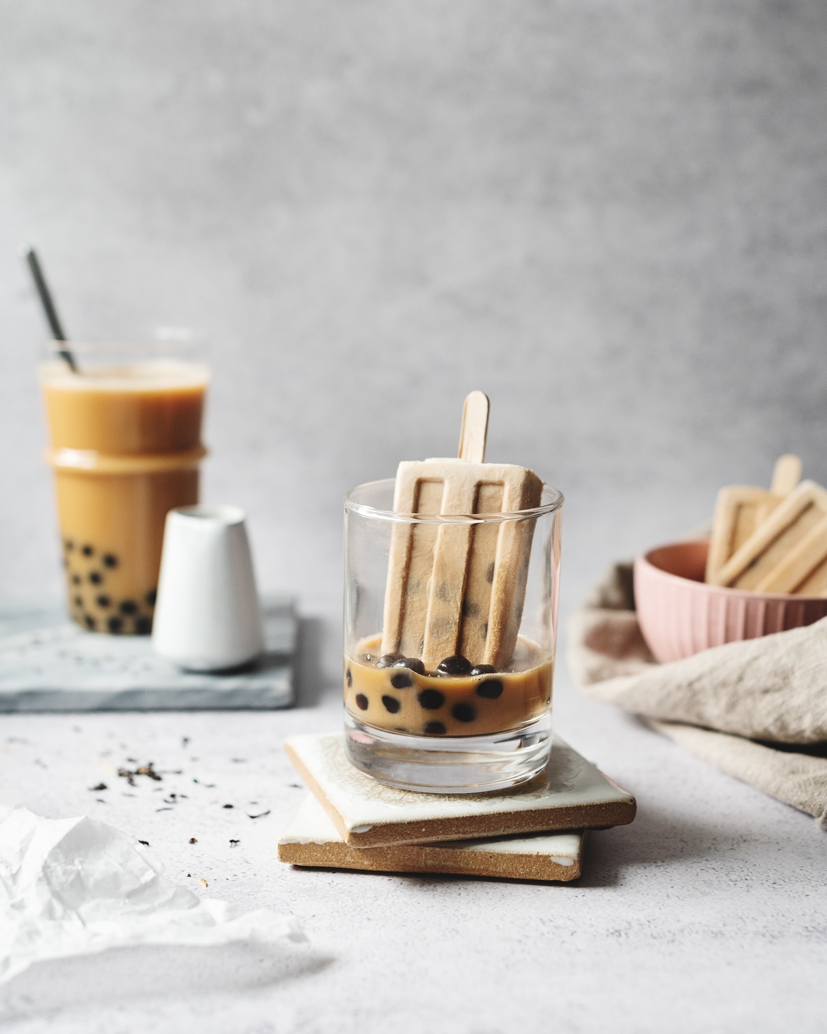 A popsicle in a glass of boba milk tea
