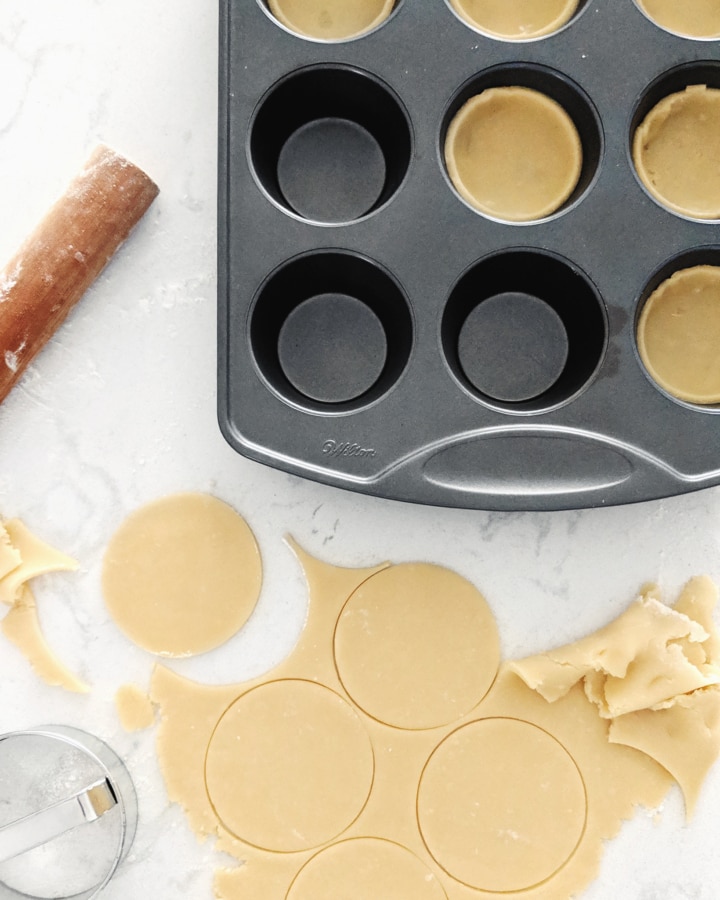 Circles of tart dough placed in muffin pan