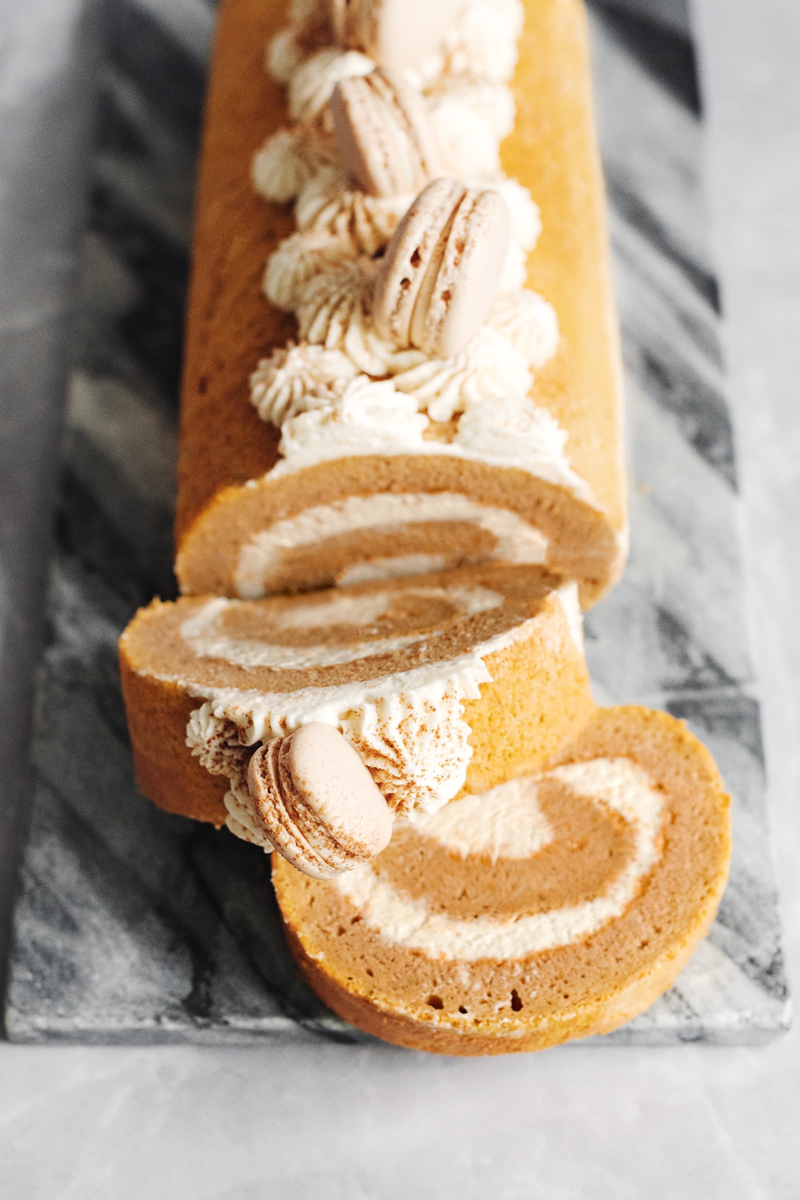 Slices cut from a pumpkin swiss roll showing the swirl pattern