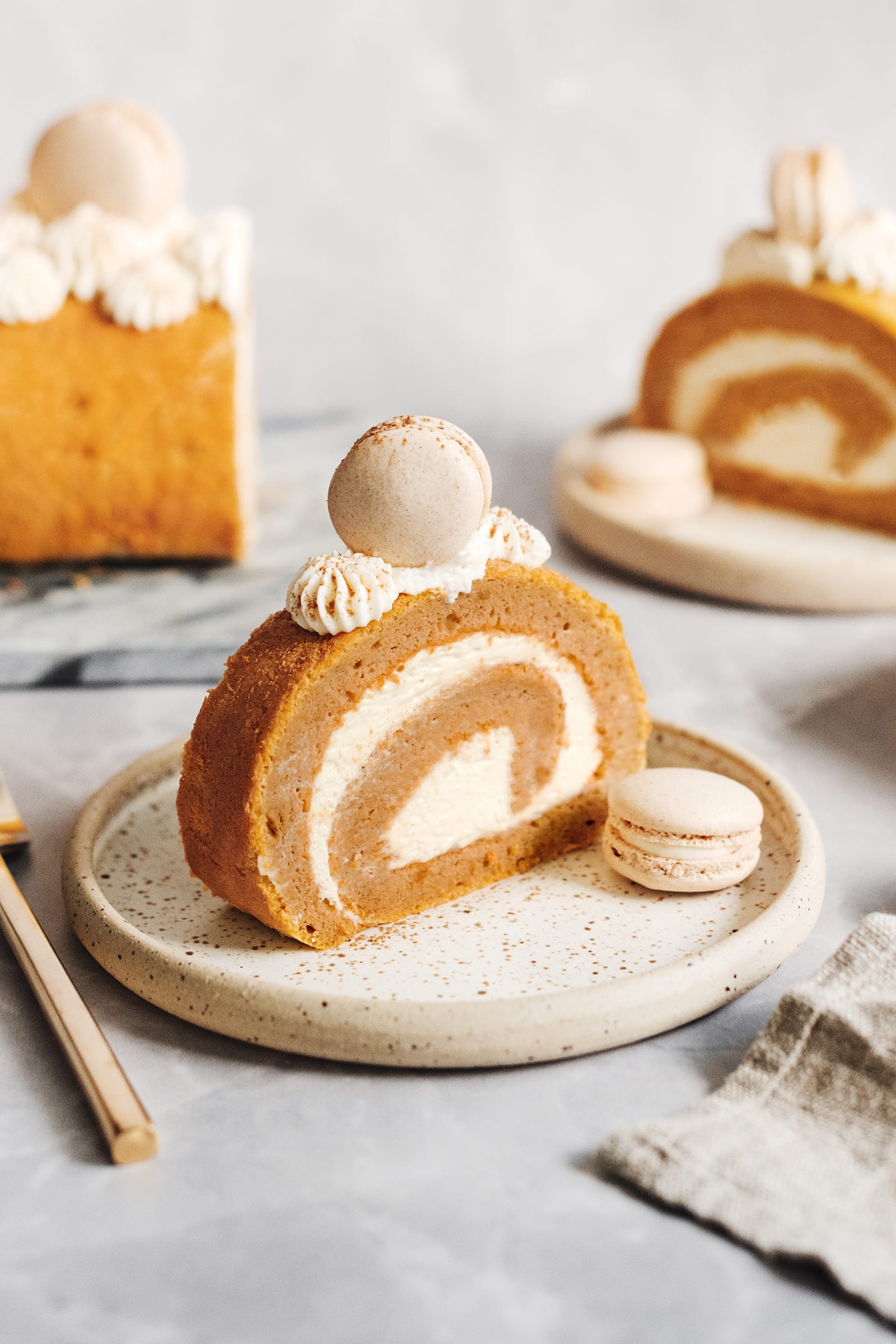 A slice of pumpkin swiss roll on a plate