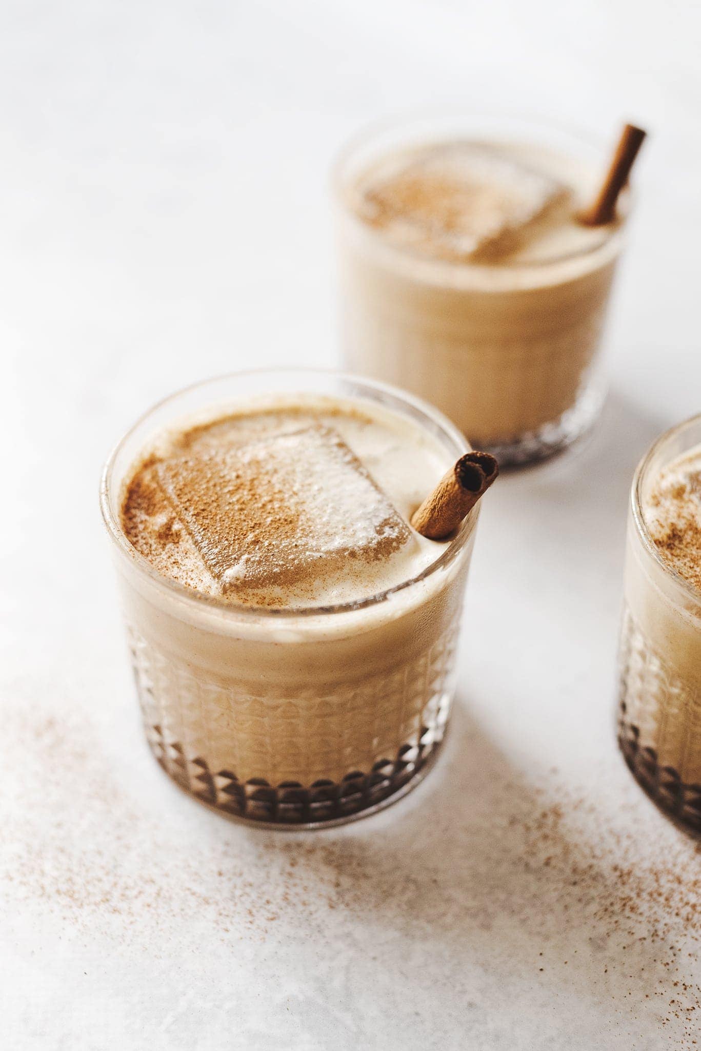 Close up of pumpkin spice white russian cocktails and large ice cubes
