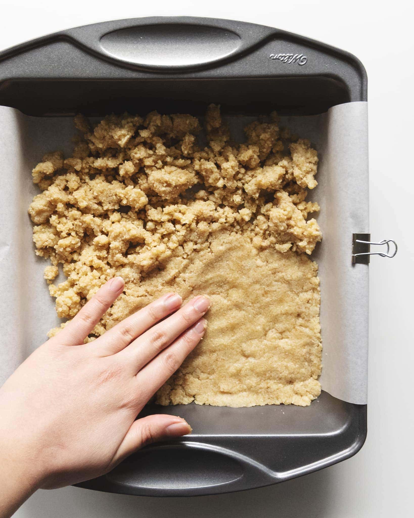 Pressing almond shortbread into pan