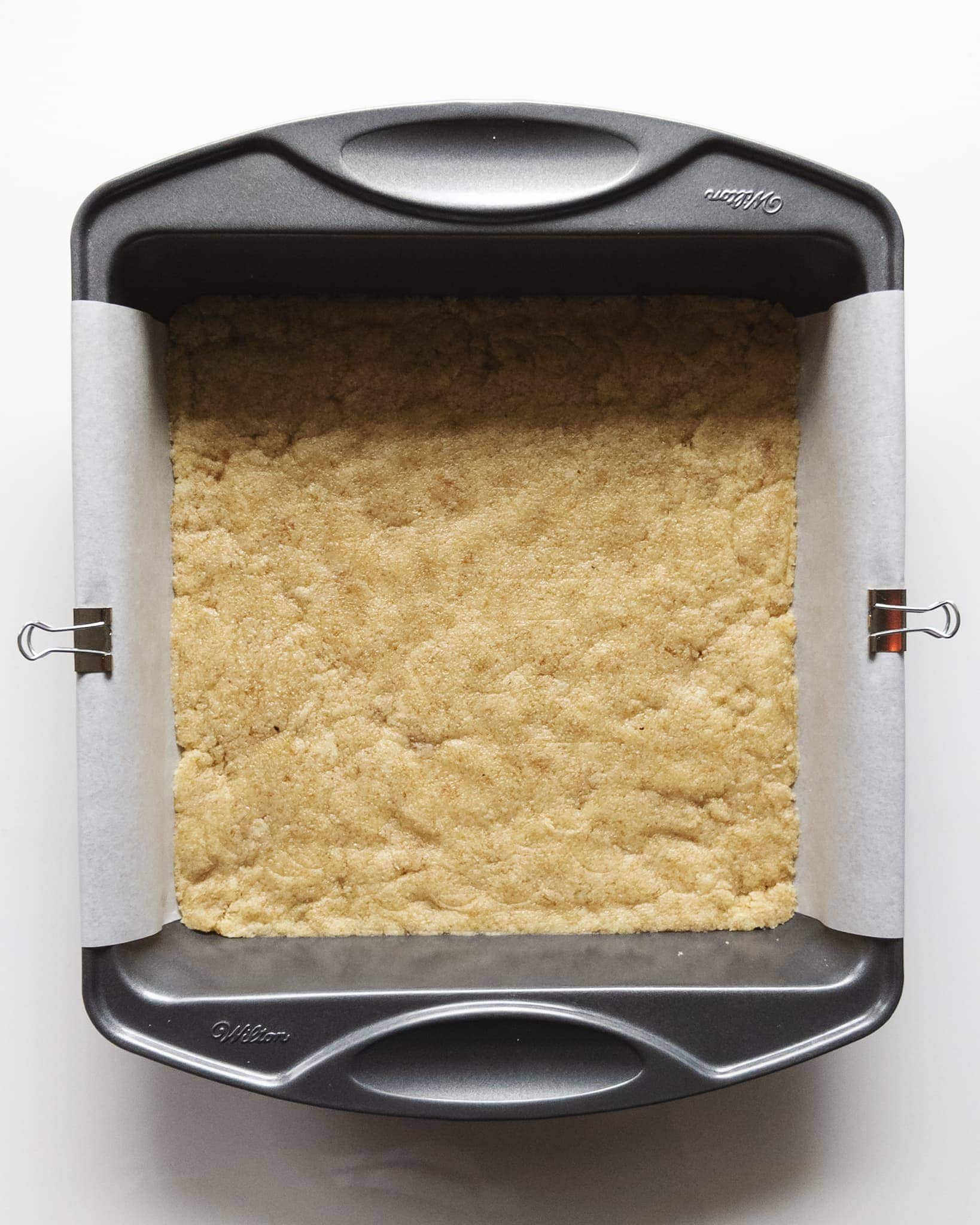 Pressed almond shortbread layer into pan