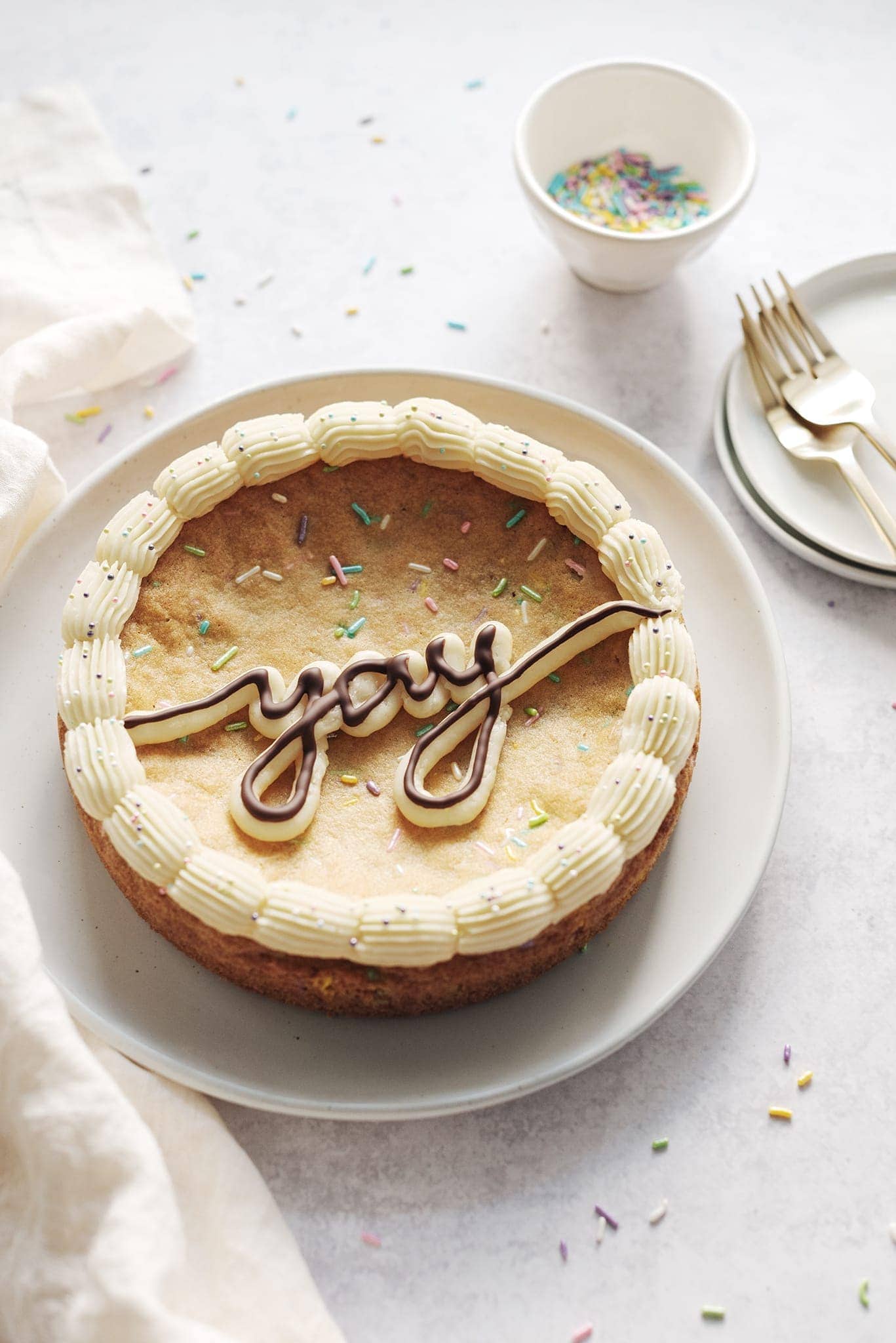 Cookie cake with the word "yay" piped in buttercream