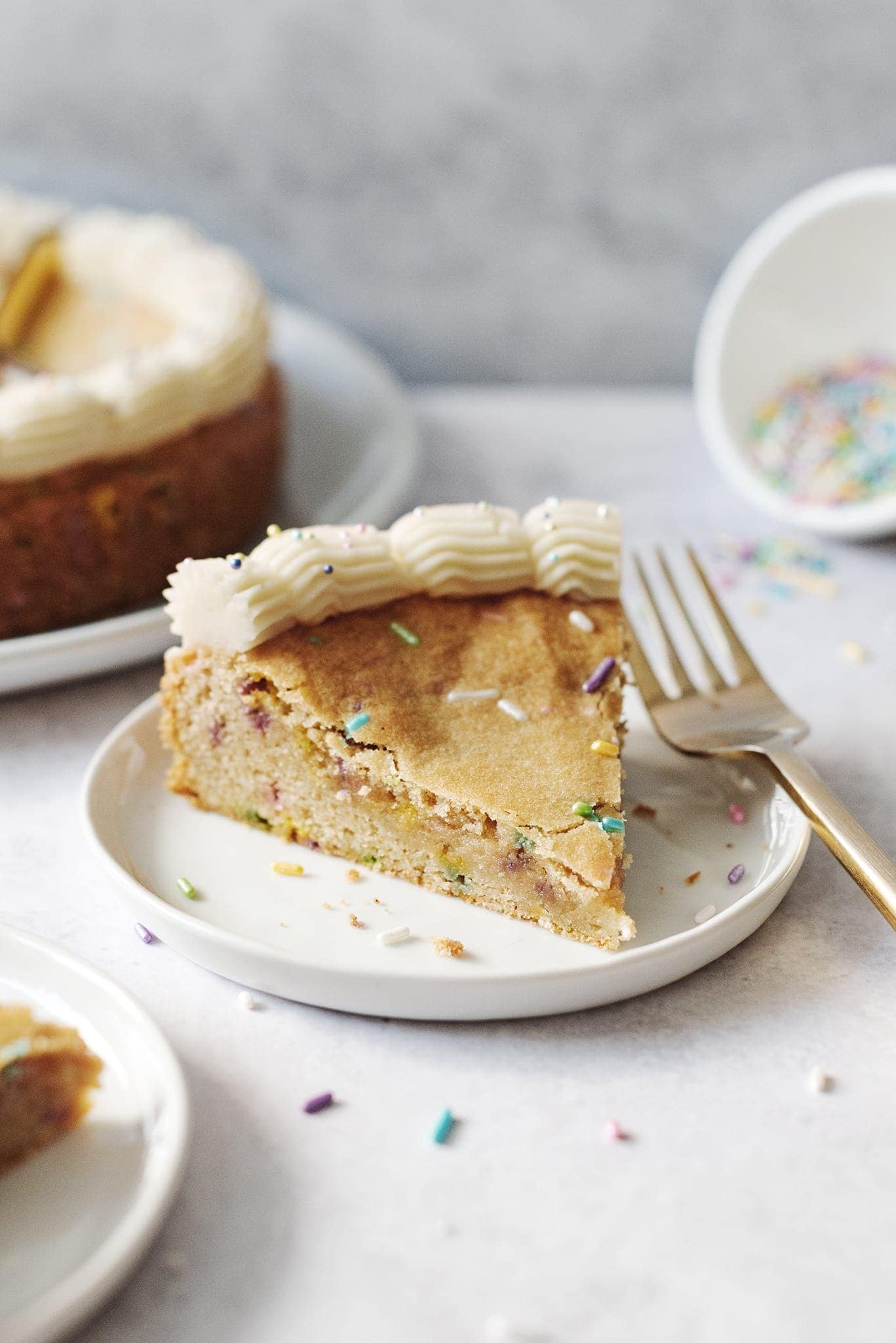 A slice of cookie cake on a plate