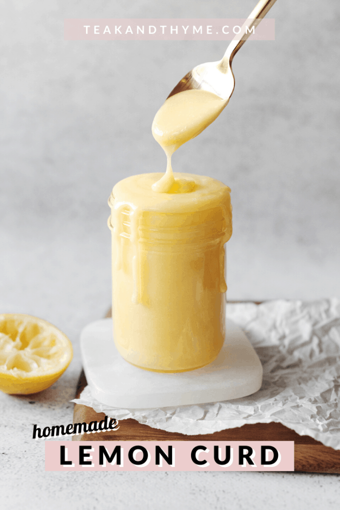 Spoon dripping lemon curd into glass jar