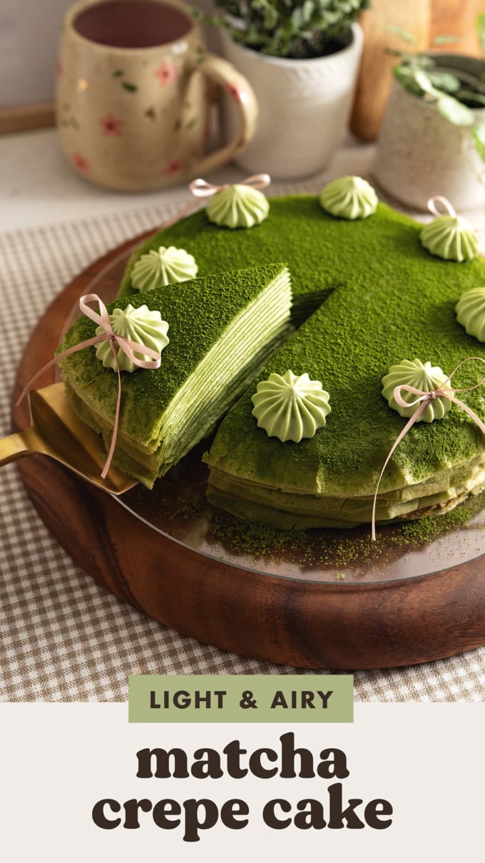 A slice of matcha crepe cake being slightly lifted from the rest of the cake.
