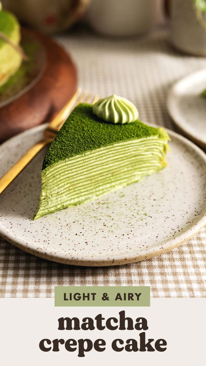 A slice of matcha crepe cake on a speckled plate.