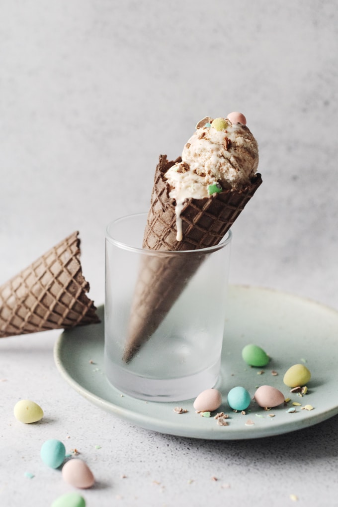 Mini egg ice cream in chocolate cone standing up in a glass