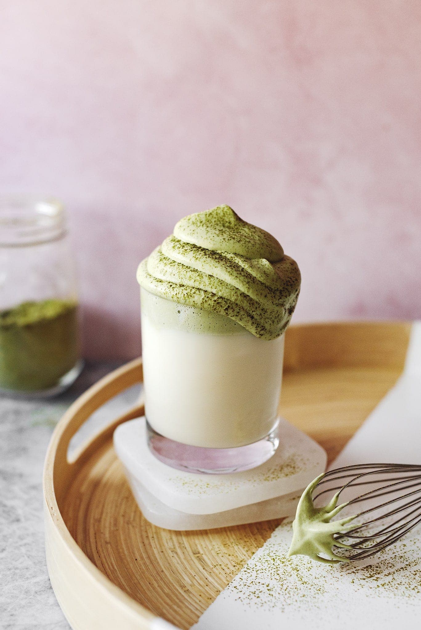 Whipped matcha latte on wood tray