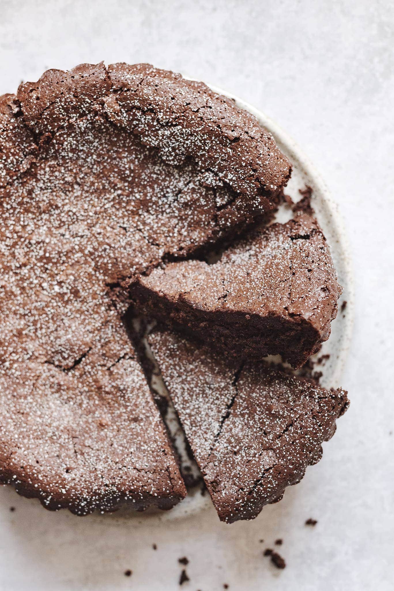 Slices cut out of a chocolate cake dusted with powdered sugar