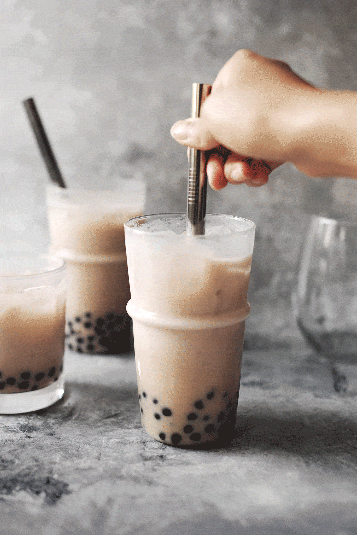 Stirring boba pearls with straw