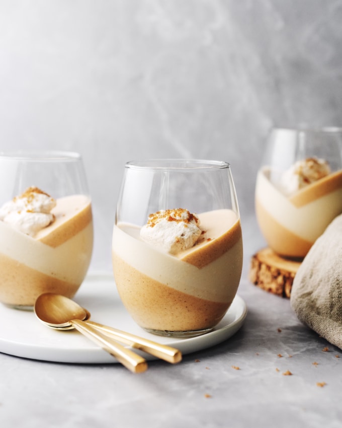 Pumpkin panna cotta topped with whipped cream in a glass