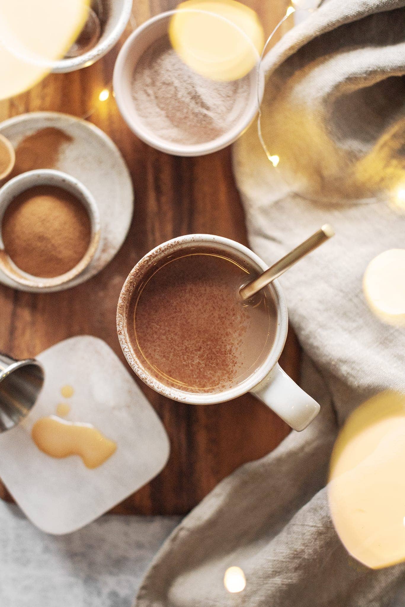 A mug of Amarula caffe mocha on wooden board with twinkle lights