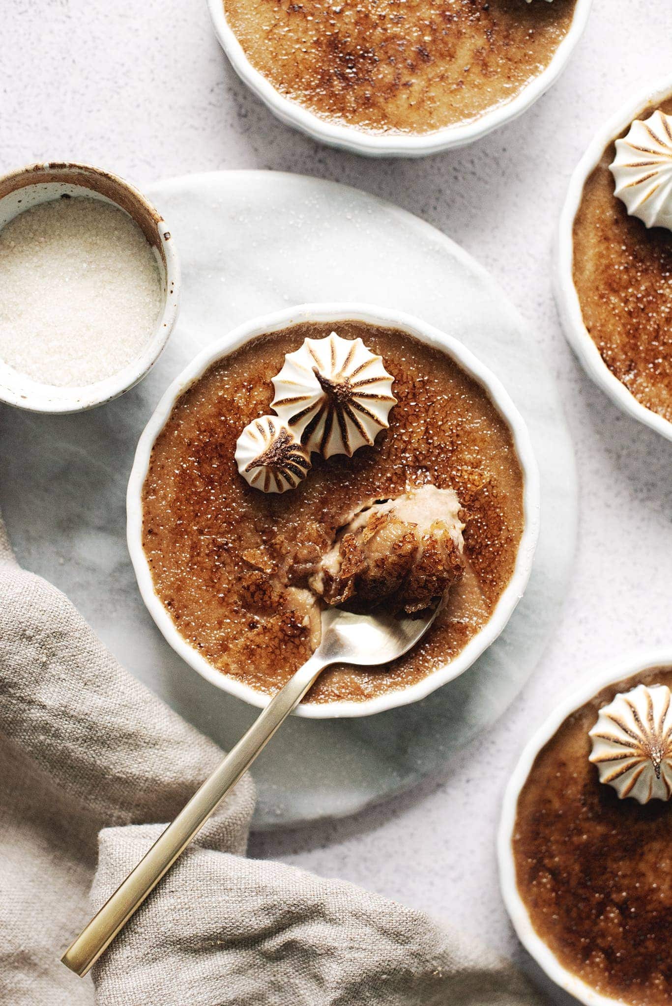 Spoonful of crème brûlée with caramelized sugar shards
