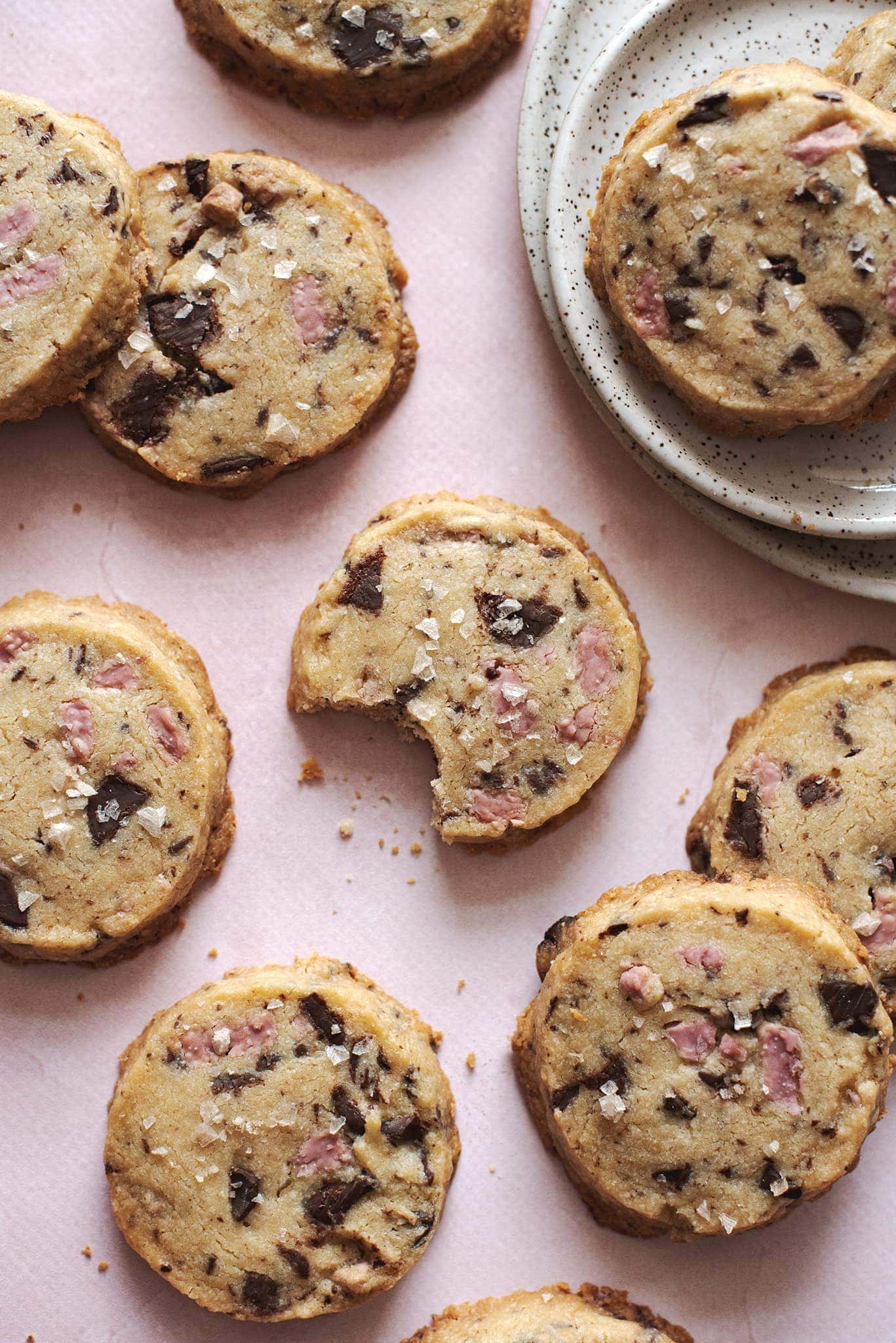 A bite taken out of a ruby chocolate shortbread cookie