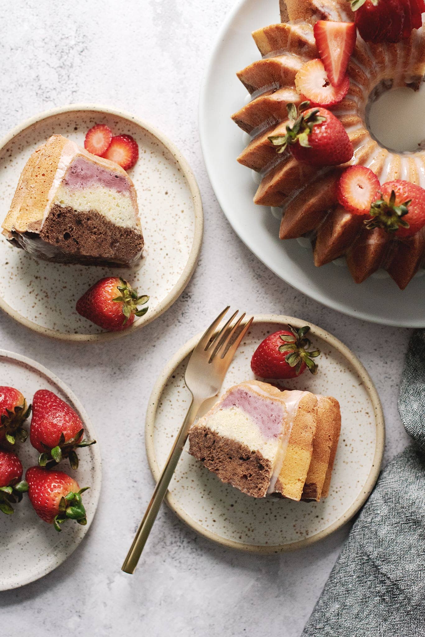 Slices of neapolitan bundt cake on plates