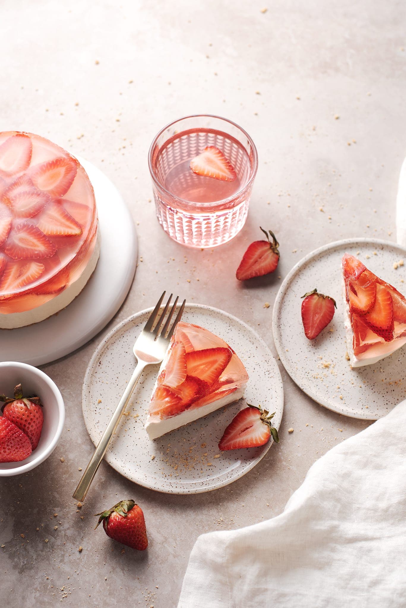 Slices of strawberry jelly cheesecake on small plates
