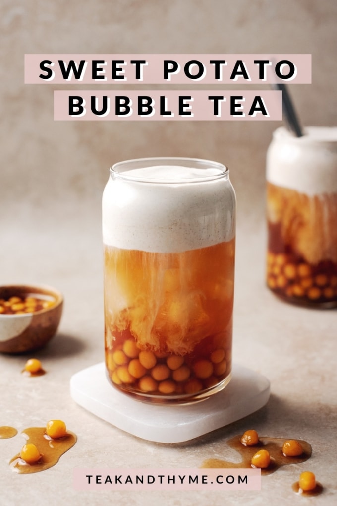 Glass of sweet potato bubble tea with sweet potato boba pearls and a layer of sweet cream dripping into black tea