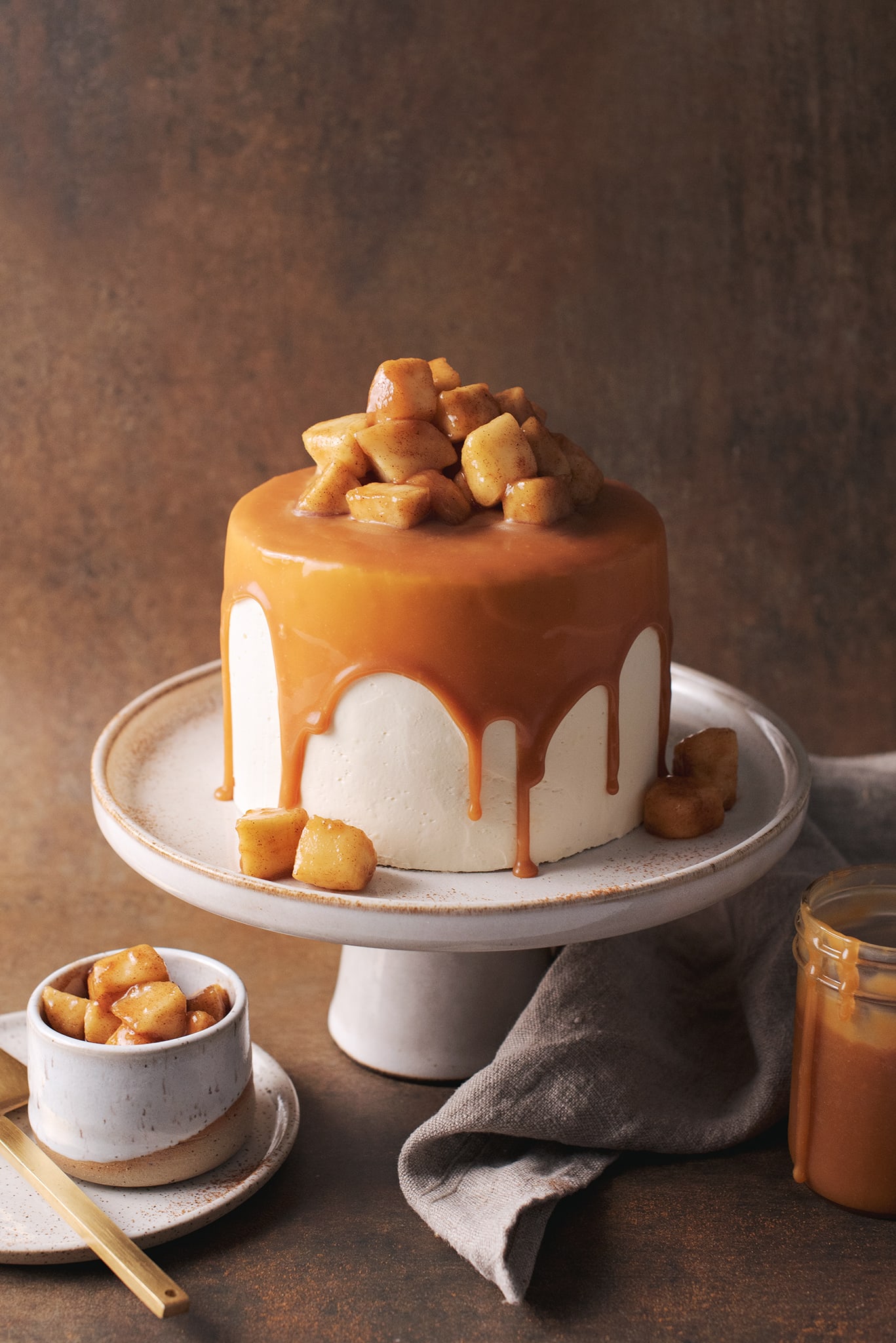 caramel apple cake with caramel drips on cake stand