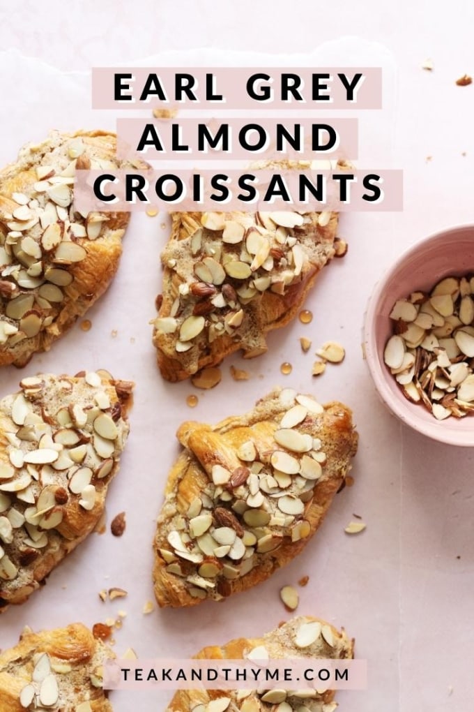 Almond croissants sprinkled with sliced almonds on pink background