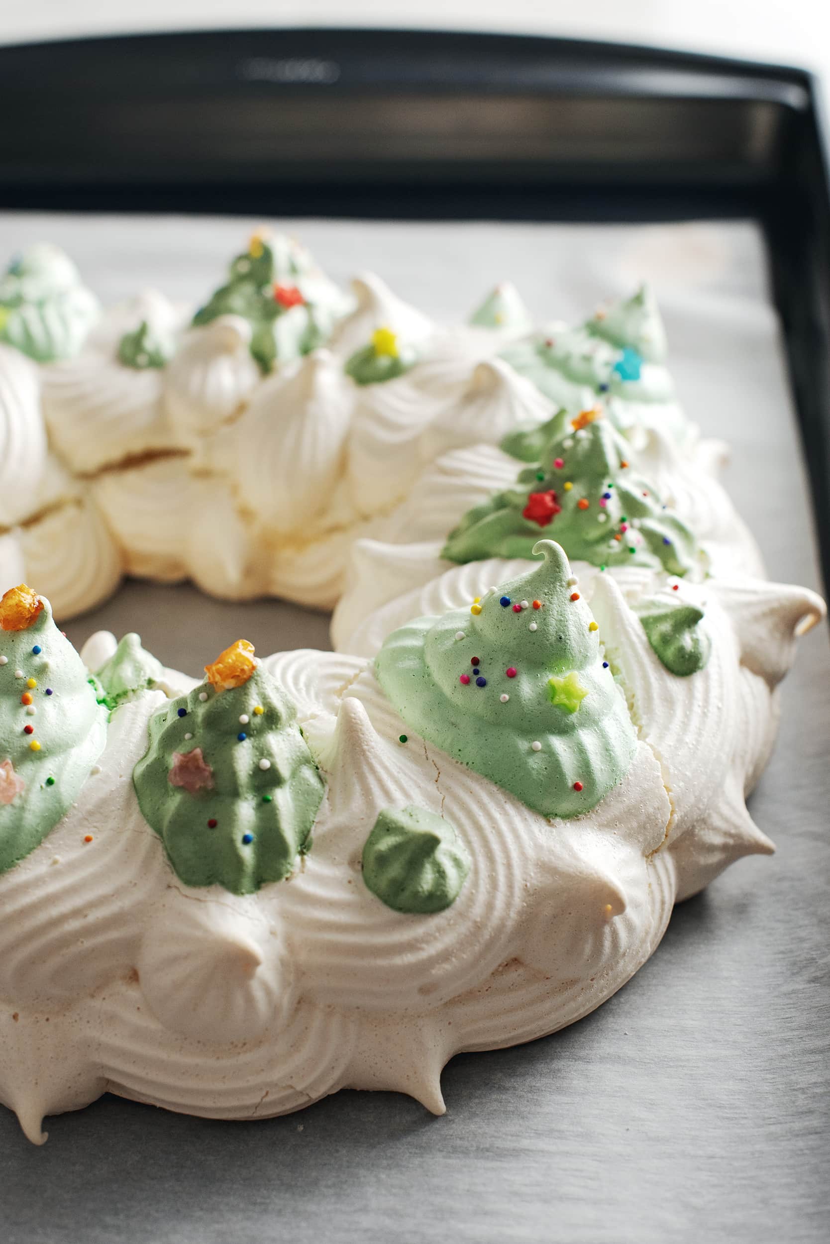 baked pavlova wreath with christmas trees on top
