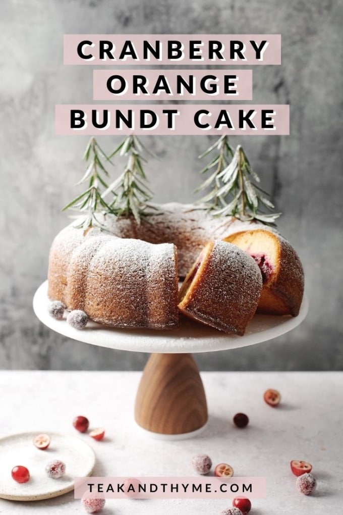 cranberry orange bundt cake with slices cut out of it on cake stand