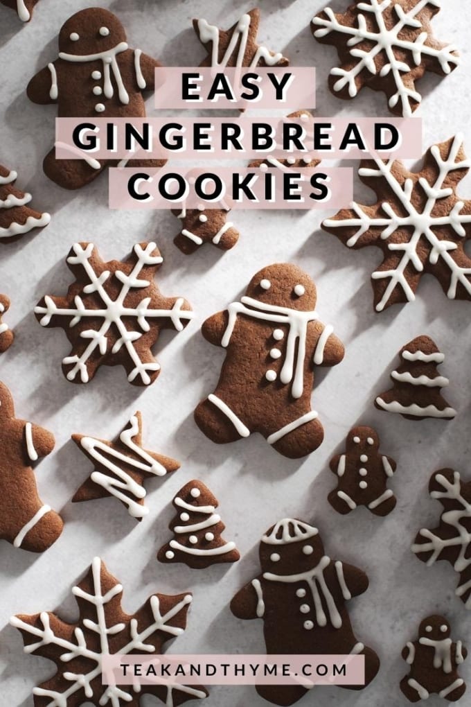 decorated gingerbread men and snowflakes on grey surface