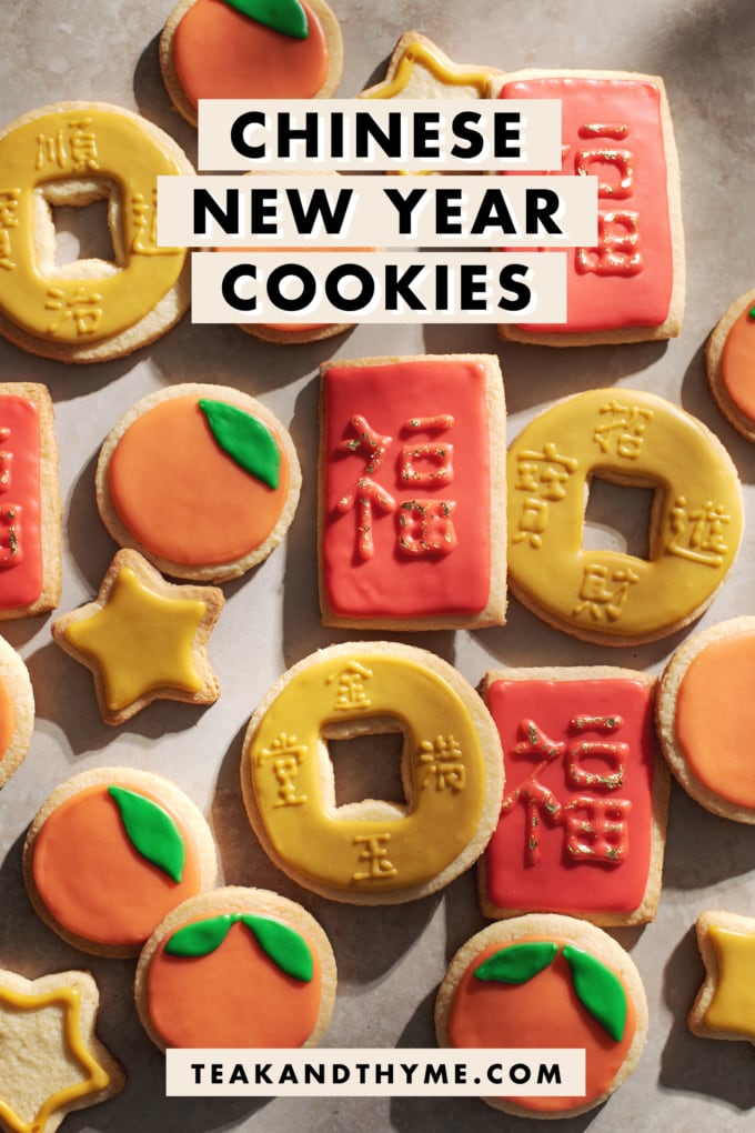 chinese new year cookies decorated as red envelopes, mandarin oranges, and coins