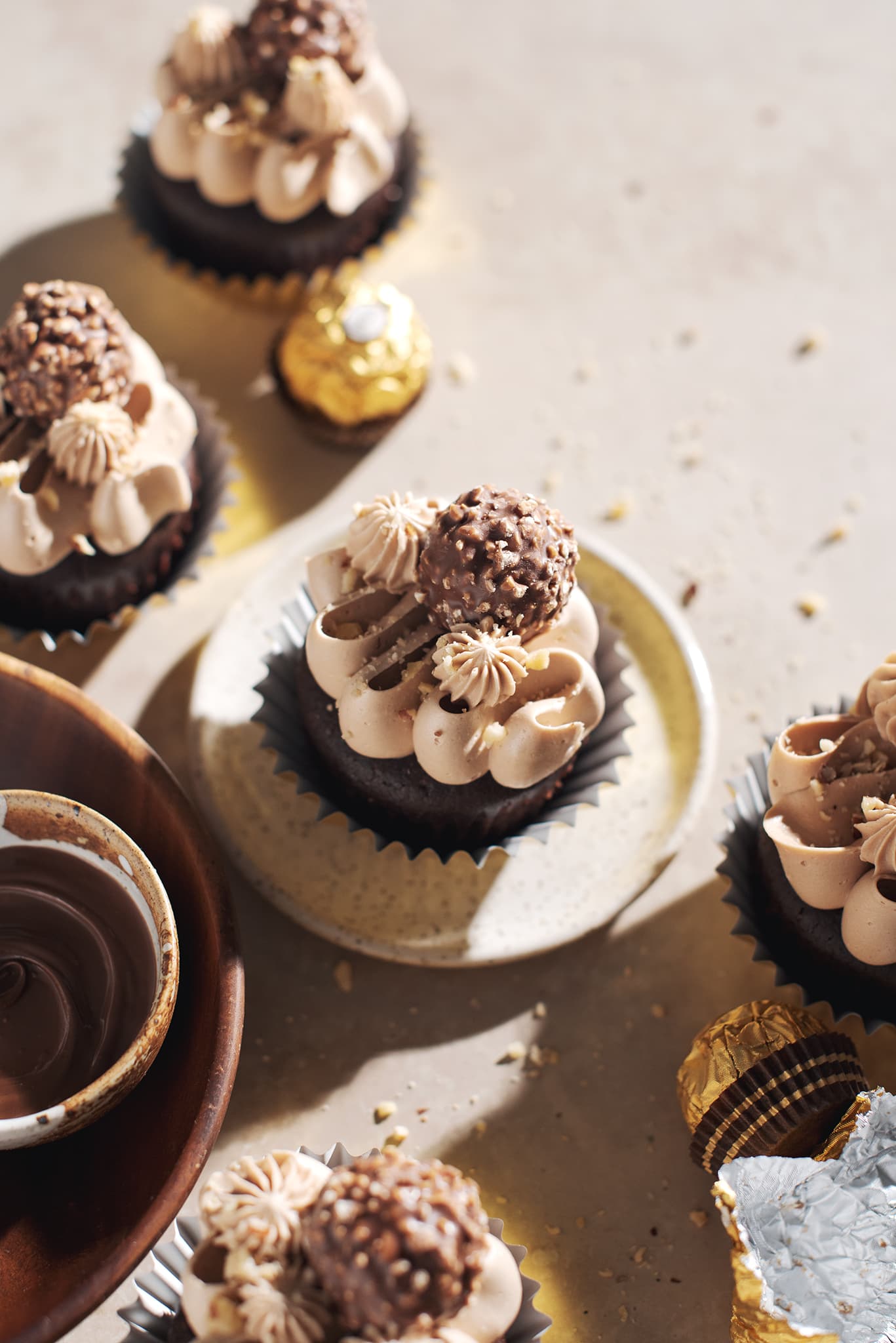 ferrero rocher cupcake on plate topped with chocolate buttercream