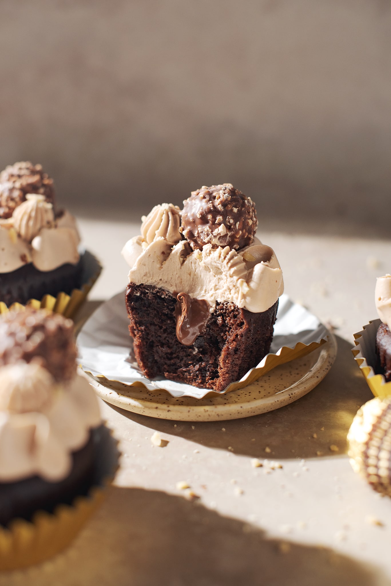 ferrero rocher cupcake cut in half to show hazelnut nutella filling inside