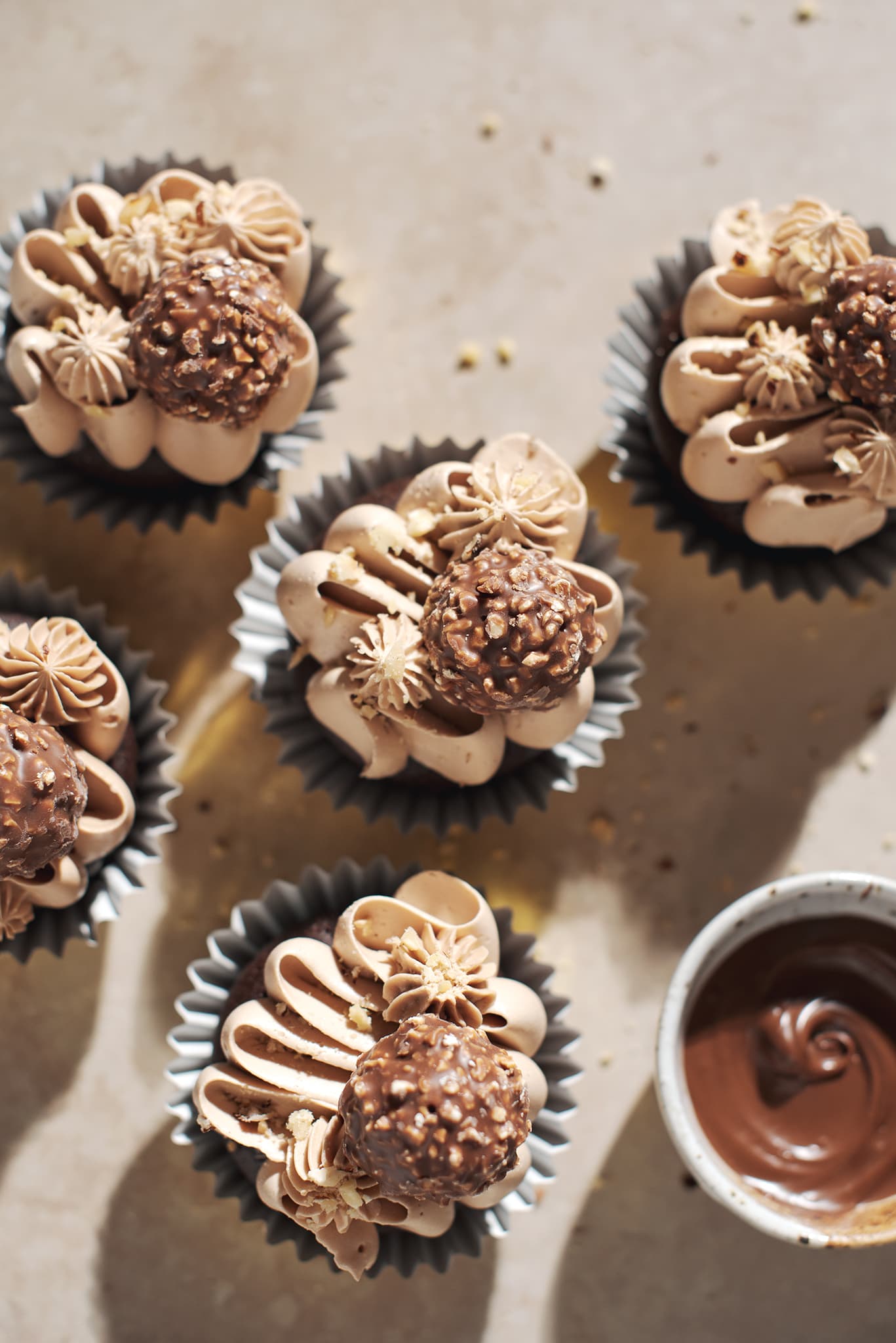 several ferrero rocher cupcakes in cupcake liners