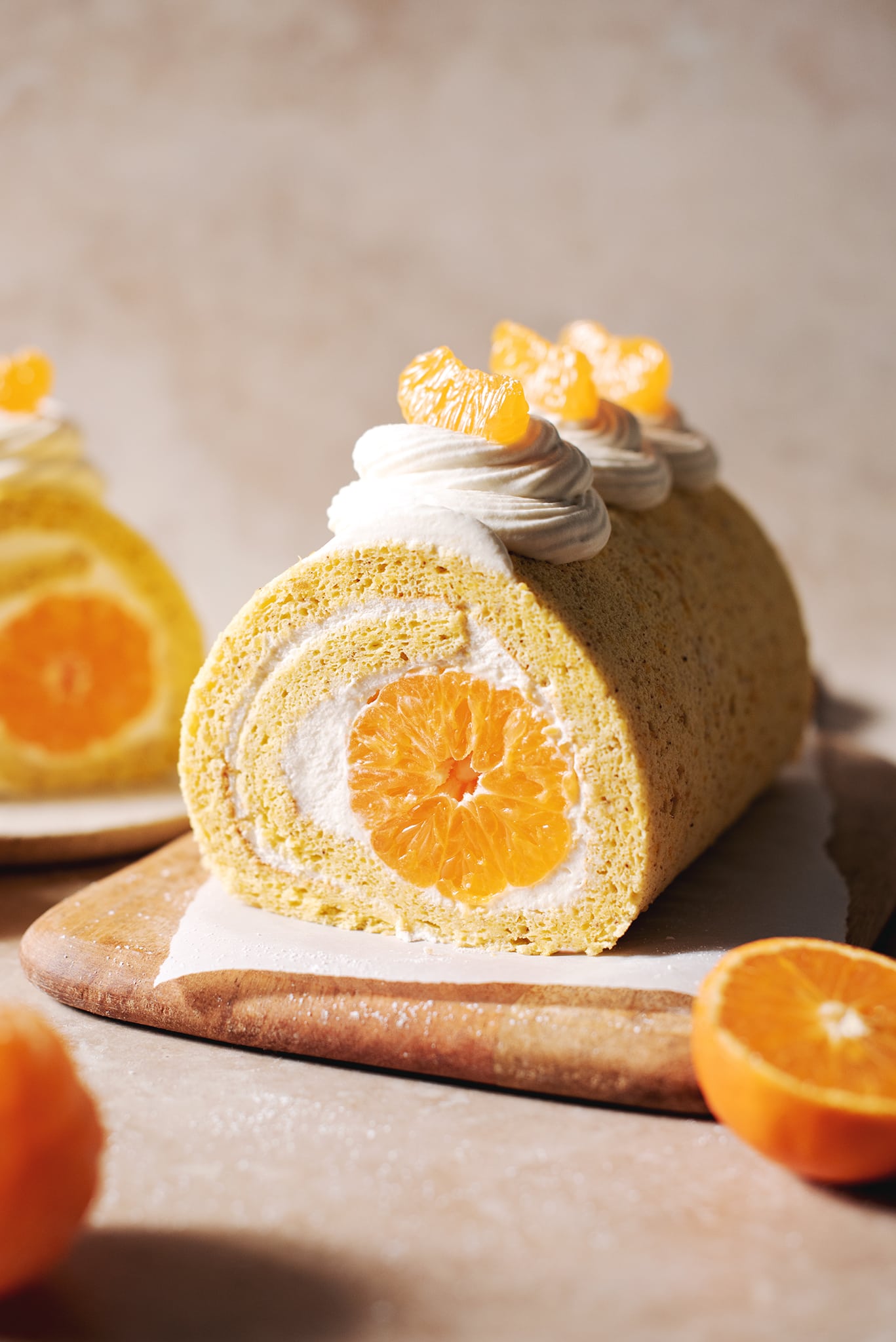 orange swiss roll cake on wooden platter