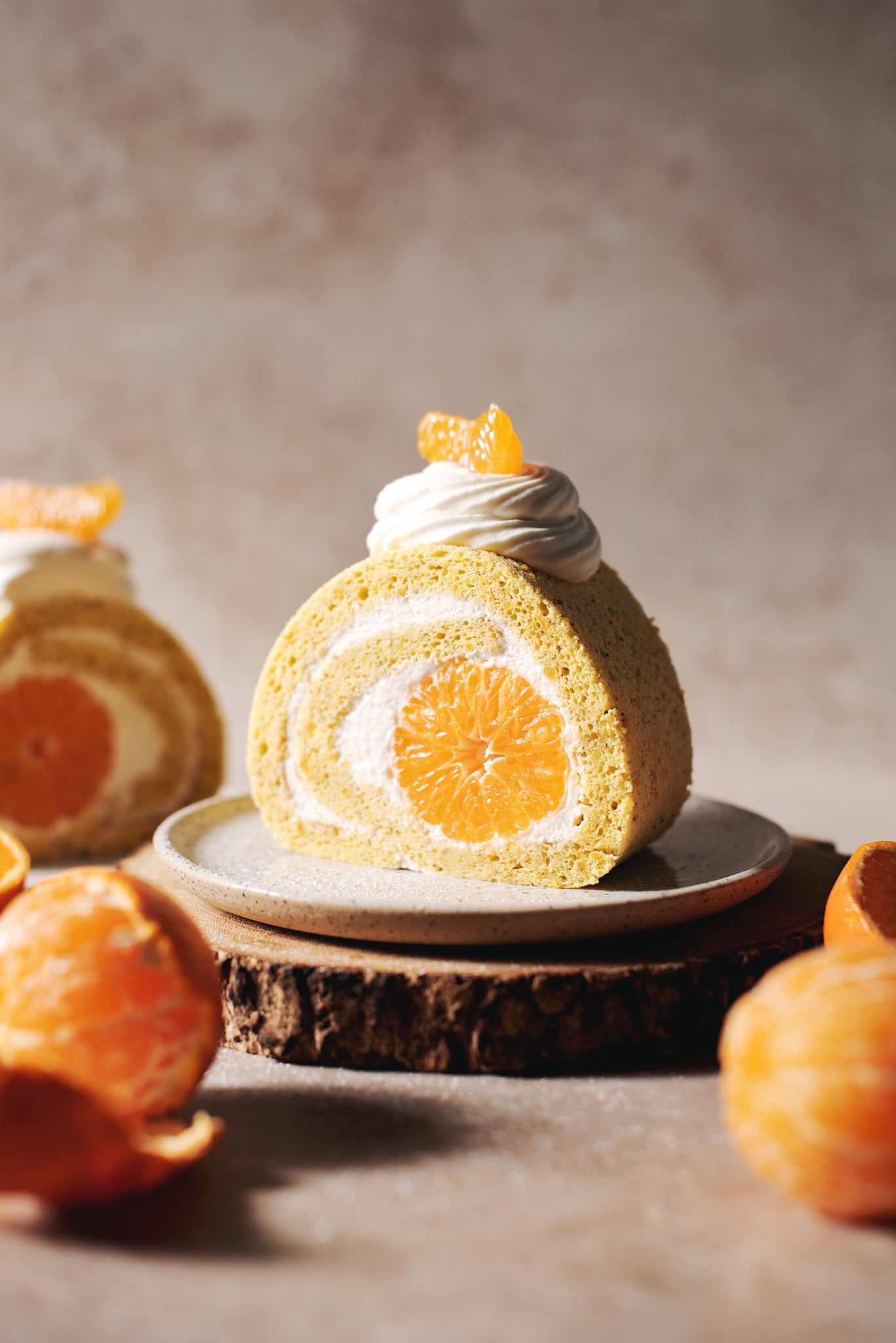 slice of orange swiss roll with mandarin orange in the middle