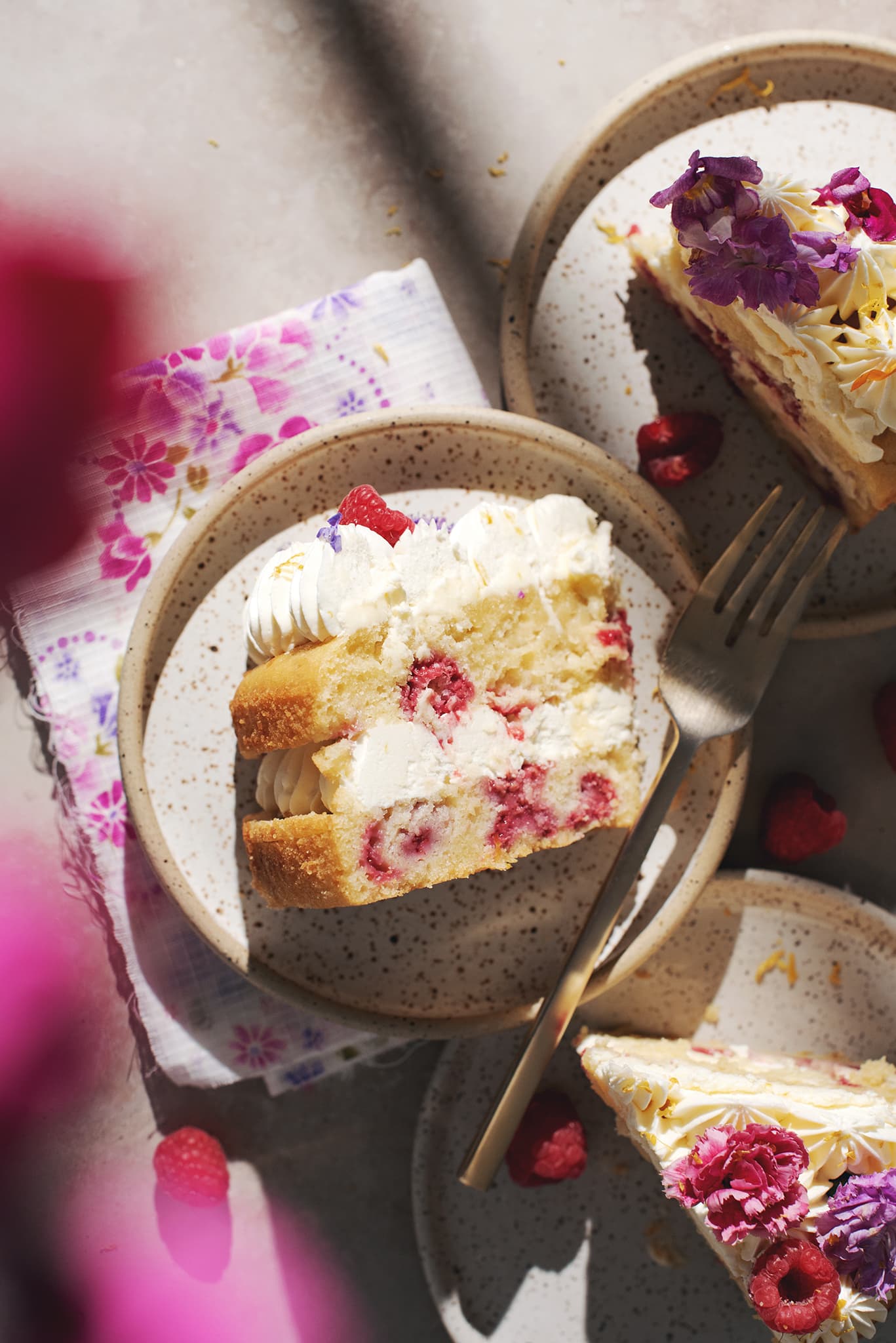 Slices of lemon raspberry cake on plates.