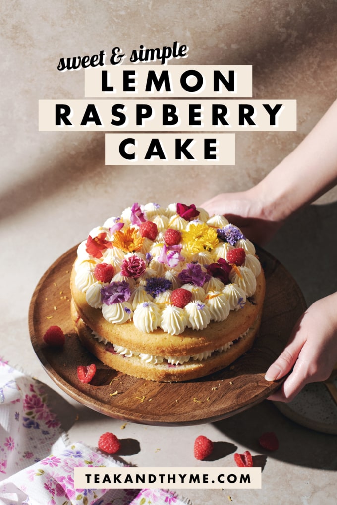 Hands holding a wooden cake stand with lemon raspberry cake on top.