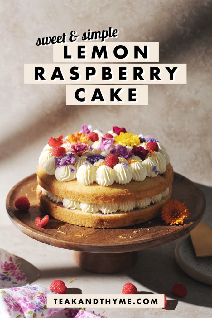 2-layered lemon raspberry cake on a wooden cake stand.