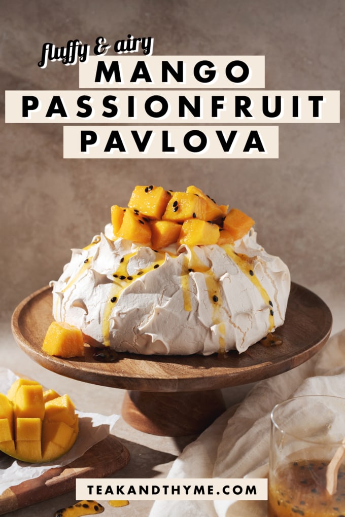 mango passionfruit pavlova on a wooden cake stand