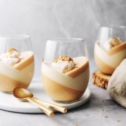 Pumpkin panna cotta topped with whipped cream in a glass