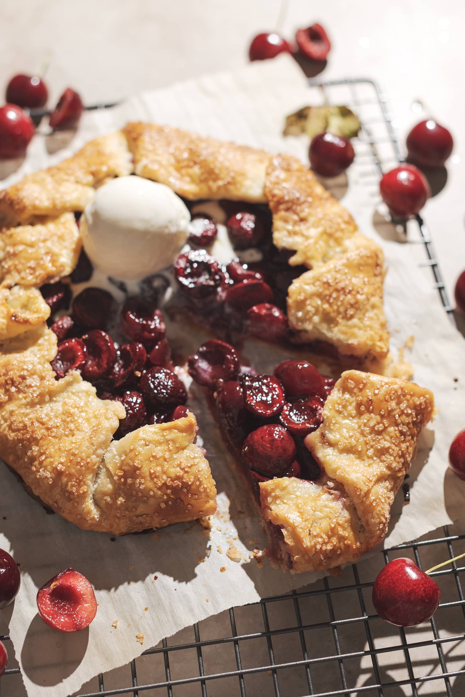 Cherry galette with a triangular slice cut out of it.