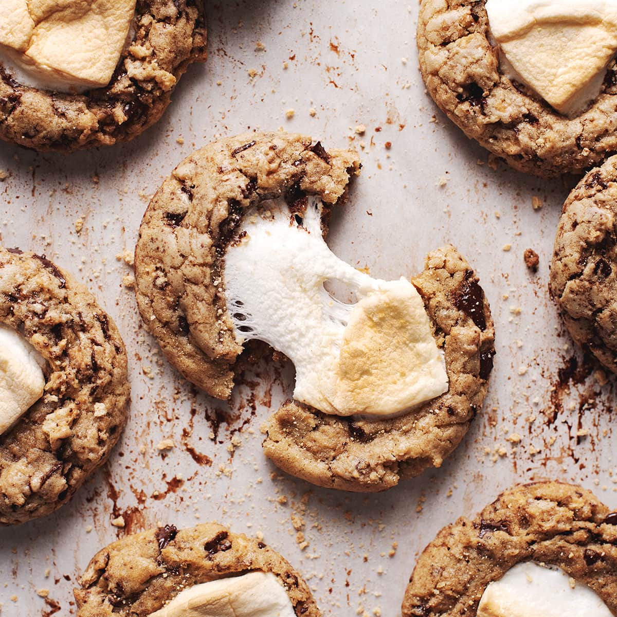 chocolate chip cookie pulled in apart to show gooey marshmallow pull