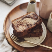 Stack of banana bread slices on wood platter