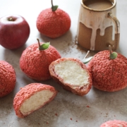 Apple cream puff cut in half to show whipped cram filling inside