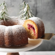 a slice of cranberry orange bundt cake lifted by cake server