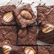 Squares of creme egg brownies with chocolate drizzle